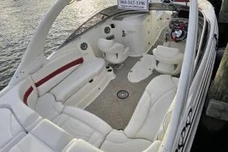 Slide: The Image of 2008 Larson LXi 288 boat interior with white seating and red accents. - 40