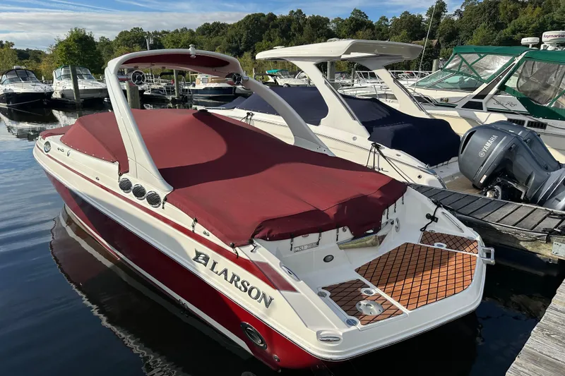 Slide: The Image of 2008 Larson LXi 288 boat with red cover docked at marina. - 5