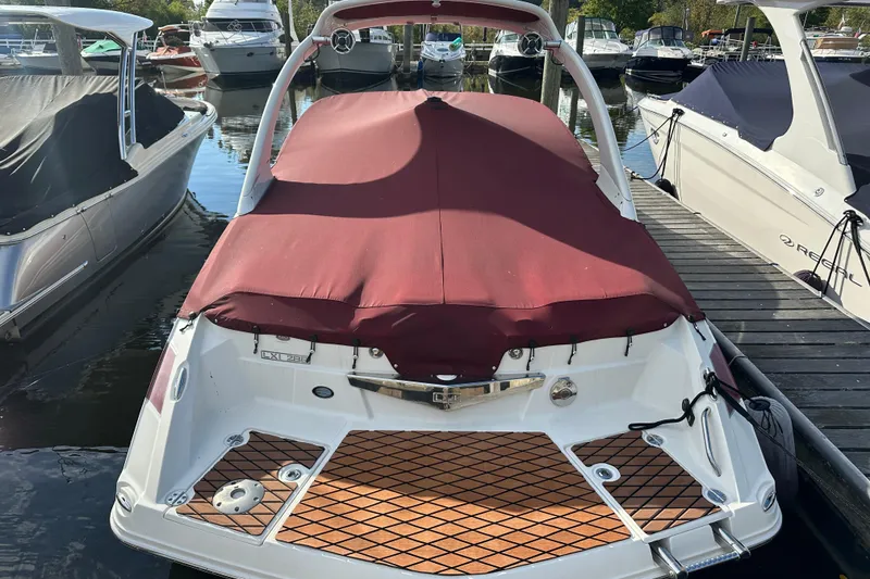 Slide: The Image of 2008 Larson LXi 288 boat with maroon cover docked at marina. - 7