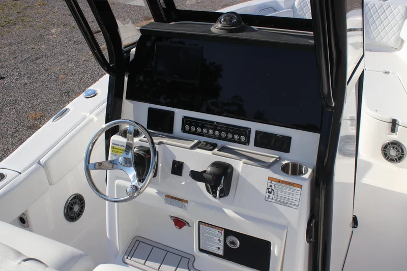 Slide: The Image of 2026 Sea Fox 248 Commander boat dashboard with steering wheel and control panel. - 10