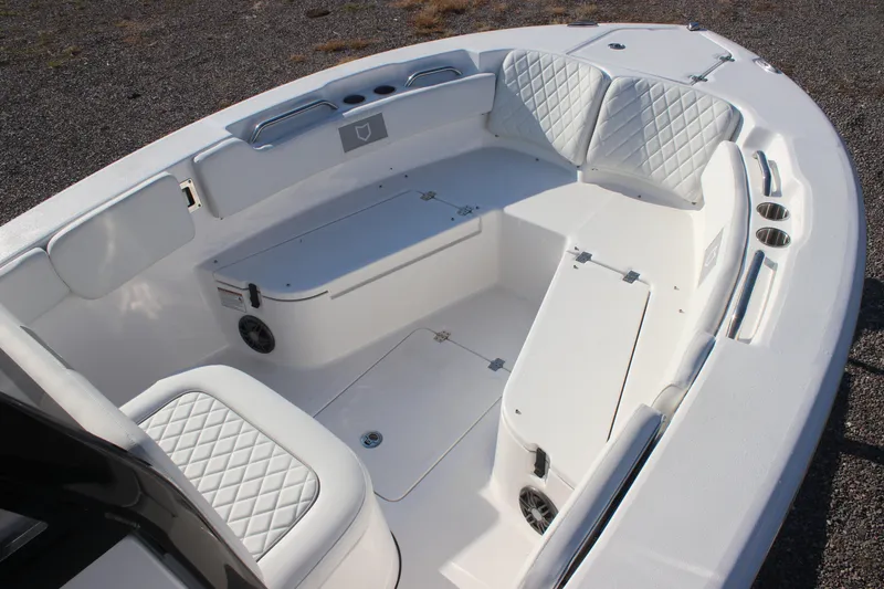 Slide: The Image of 2026 Sea Fox 248 Commander boat interior with white cushioned seating and storage compartments. - 11