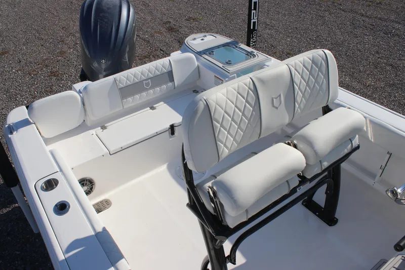Slide: The Image of 2026 Sea Fox 248 Commander boat interior with white cushioned seating and sleek design. - 12