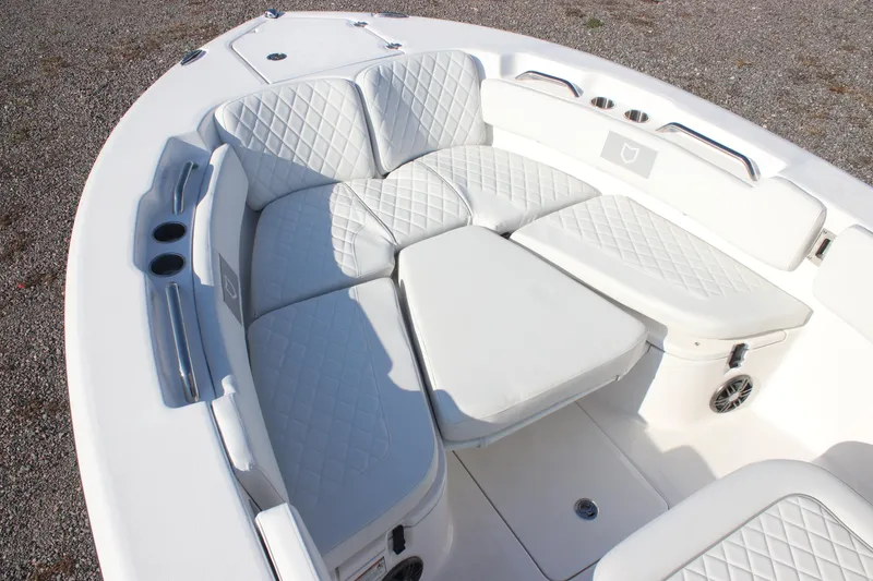 Slide: The Image of 2026 Sea Fox 248 Commander boat with white cushioned seating and cup holders. - 15