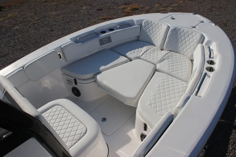 Slide: The Image of 2026 Sea Fox 248 Commander boat interior with white cushioned seating and diamond stitching. - 17