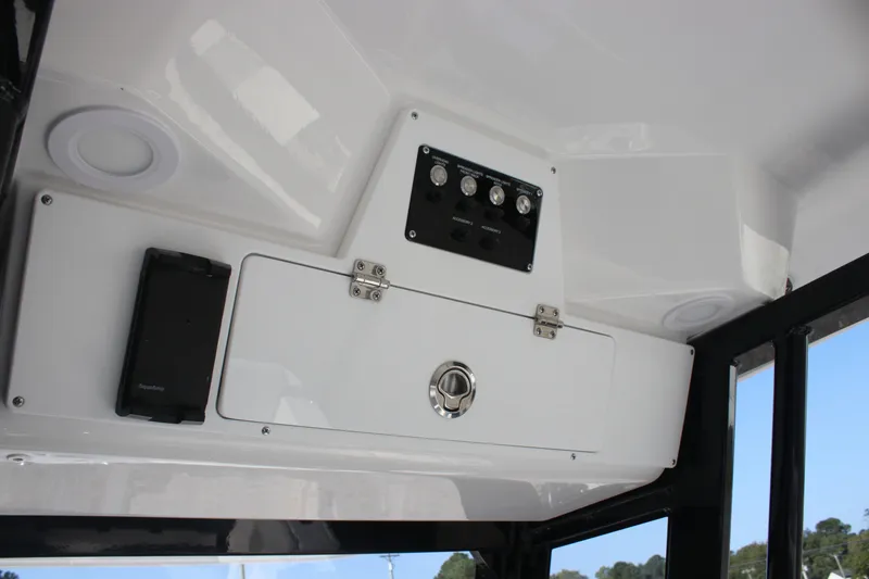Slide: The Image of 2026 Sea Fox 248 Commander boat interior control panel and storage compartment. - 27