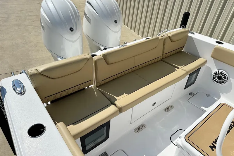 Slide: The Image of 2025 Sportsman Heritage 261 Center Console boat with beige seating and dual engines. - 16