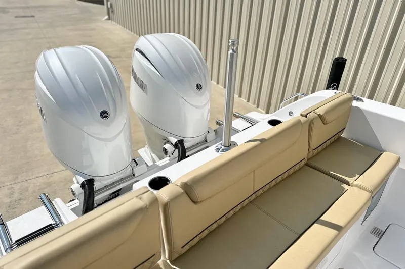 Slide: The Image of 2025 Sportsman Heritage 261 Center Console with twin outboard engines and beige seating. - 19