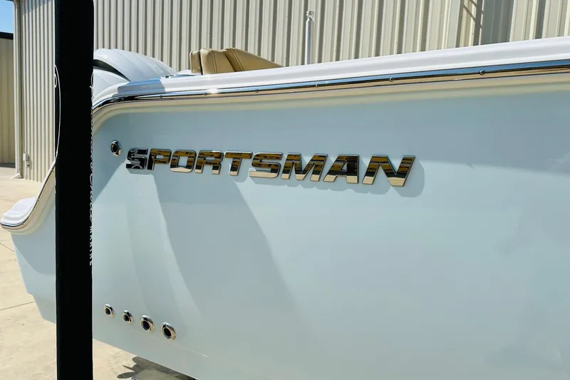 Slide: The Image of 2025 Sportsman Heritage 261 Center Console boat with chrome logo detail. - 21