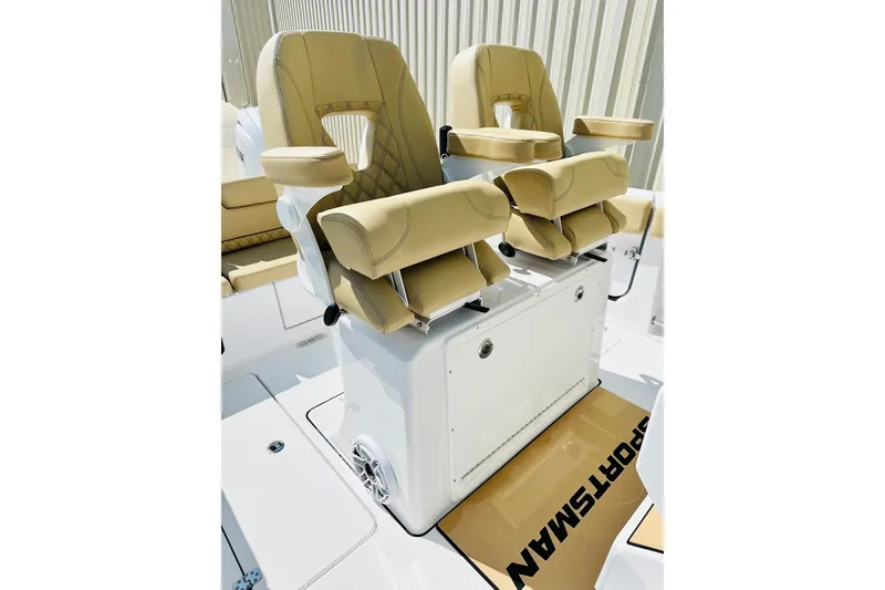Slide: The Image of 2025 Sportsman Heritage 261 Center Console boat seats with beige upholstery and armrests. - 5
