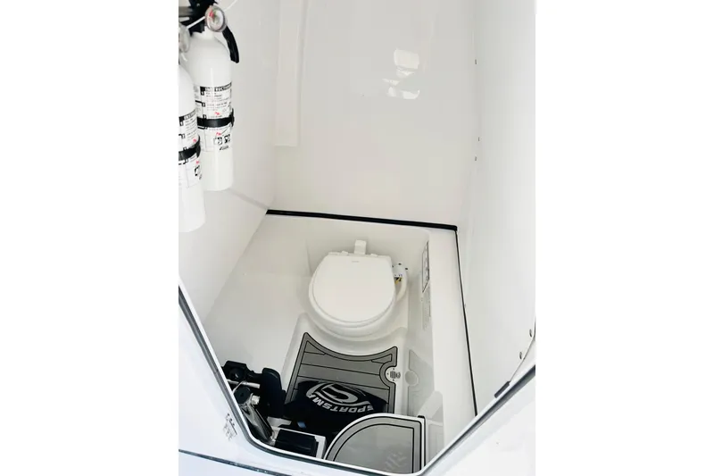 Slide: The Image of 2025 Sportsman Heritage 261 Center Console interior with toilet and fire extinguishers. - 8