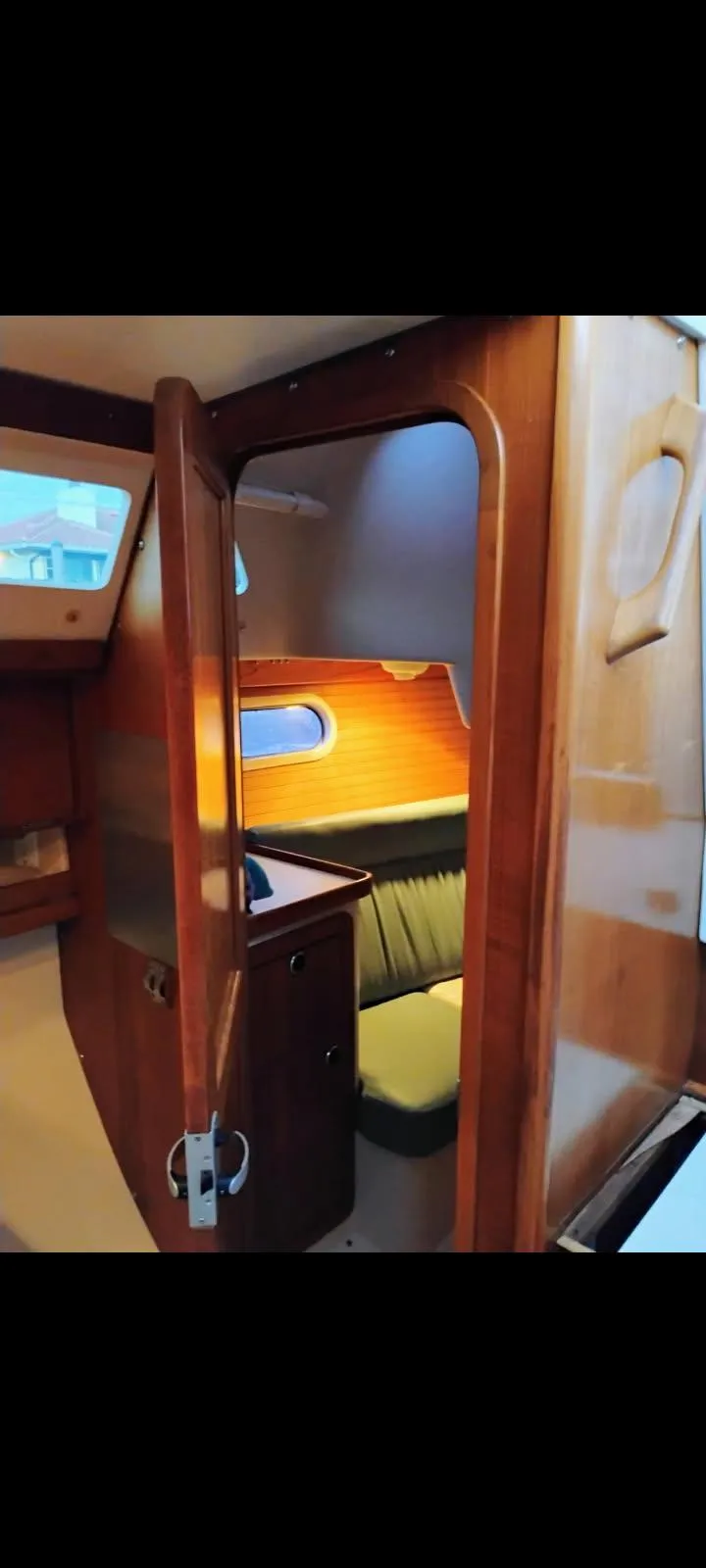 Slide: The Image of 2002 Catalina 34 Mark II interior with wood finish and cozy seating area. - 7