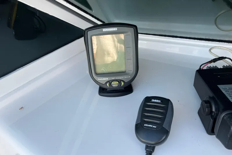 Slide: The Image of Humminbird fish finder and Uniden radio on 1983 Chris-Craft 230 Scorpion boat dashboard. - 11