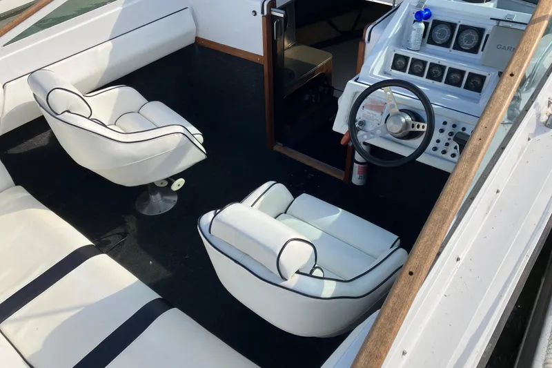 Slide: The Image of 1983 Chris-Craft 230 Scorpion interior with white seating and steering console. - 5