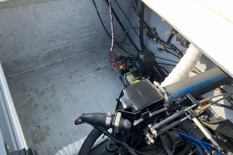 Slide: The Image of Engine compartment of a 1983 Chris-Craft 230 Scorpion boat, showing mechanical components and wiring. - 20
