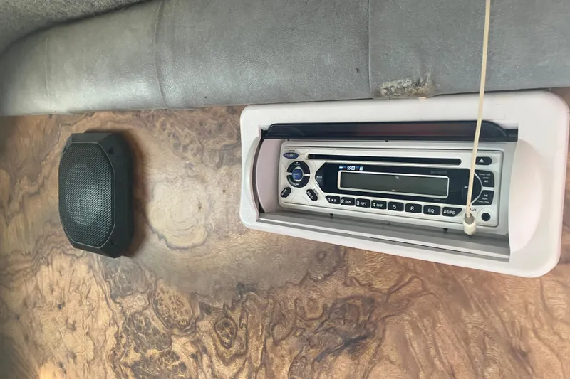 Slide: The Image of 1983 Chris-Craft 230 Scorpion interior with stereo system and speaker on wooden panel. - 15