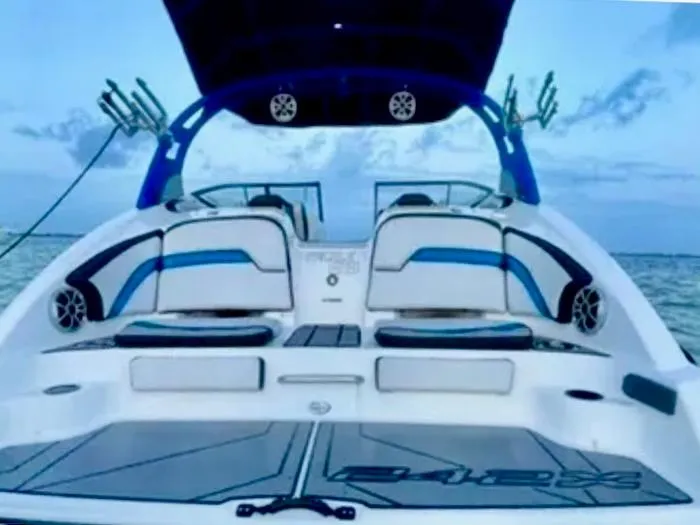 Slide: The Image of 2019 Yamaha Boats 242X E-Series on water, showcasing sleek design and spacious seating. - 6