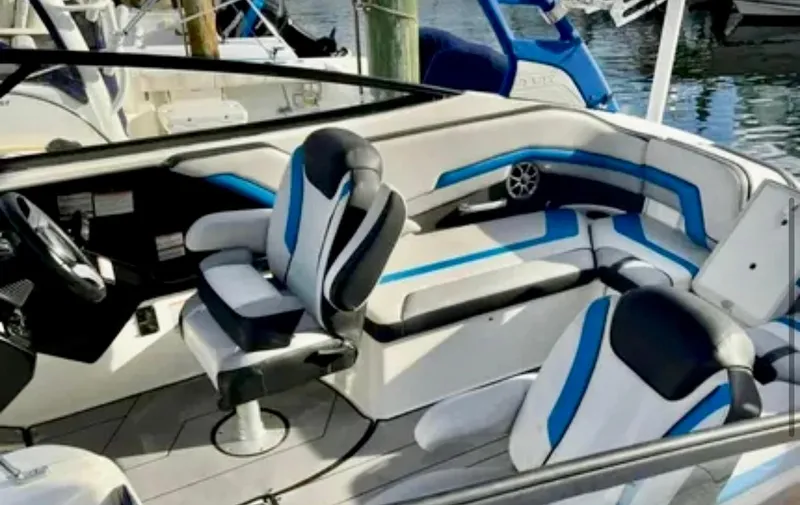 Slide: The Image of 2019 Yamaha Boats 242X E-Series interior with blue and white seating. - 7