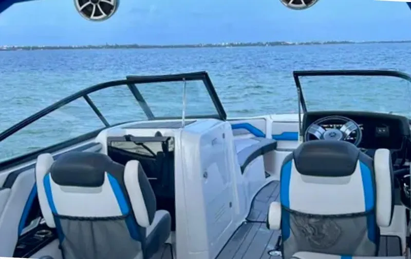 Slide: The Image of 2019 Yamaha Boats 242X E-Series interior with ocean view, featuring modern seating and controls. - 8