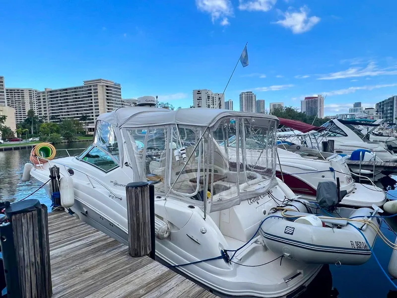 Slide: The Image of 2006 Sea Ray 340 Sundancer docked at marina with city skyline. - 16