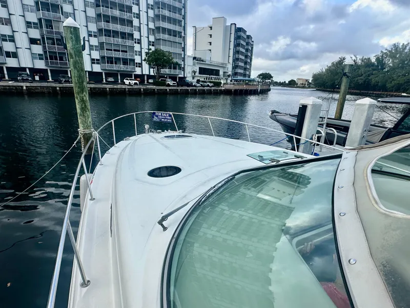 Slide: The Image of 2006 Sea Ray 340 Sundancer docked near waterfront buildings. - 21