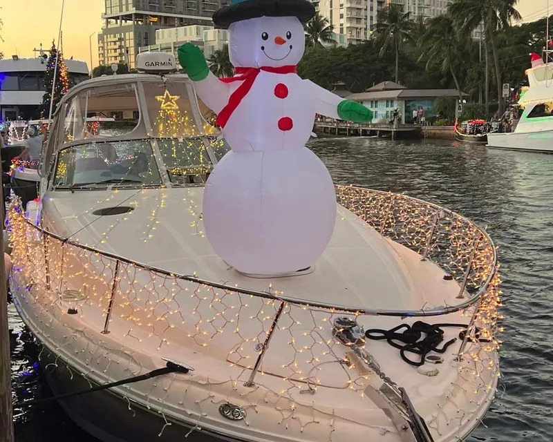 Slide: The Image of Sea Ray 340 Sundancer 2006 decorated with lights and inflatable snowman on a river. - 25