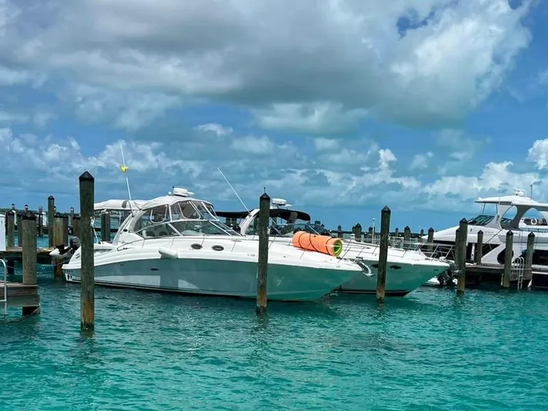 Slide: The Image of 2006 Sea Ray 340 Sundancer docked in clear turquoise water under a cloudy sky. - 27