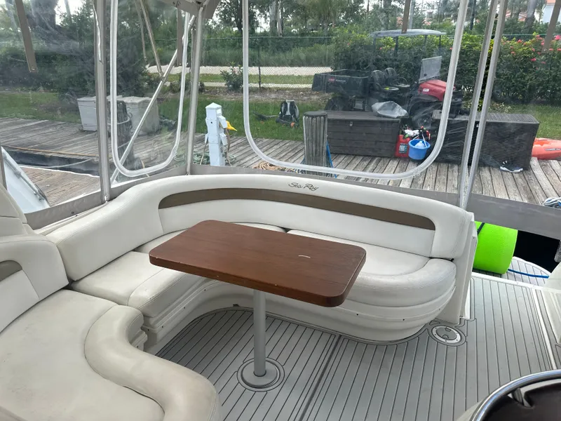 Slide: The Image of Interior seating area of a 2006 Sea Ray 340 Sundancer yacht with a wooden table. - 41