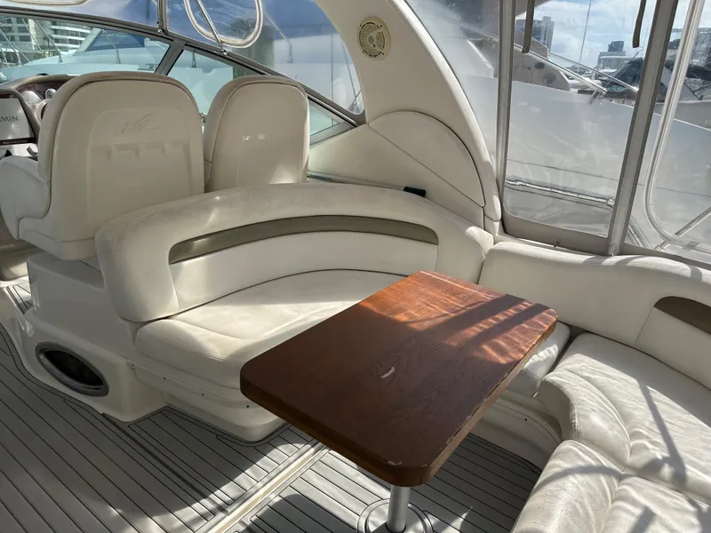 Slide: The Image of Interior of 2006 Sea Ray 340 Sundancer with white seating and wooden table. - 45