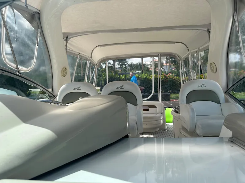 Slide: The Image of Interior of a 2006 Sea Ray 340 Sundancer boat with white seating and canopy. - 47