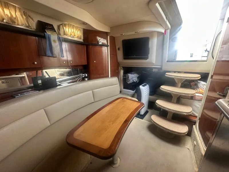 Slide: The Image of Interior of 2006 Sea Ray 340 Sundancer yacht with seating, table, and stairs. - 49