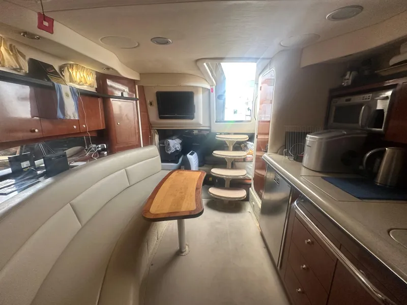 Slide: The Image of Interior of 2006 Sea Ray 340 Sundancer yacht with kitchen and seating area. - 50