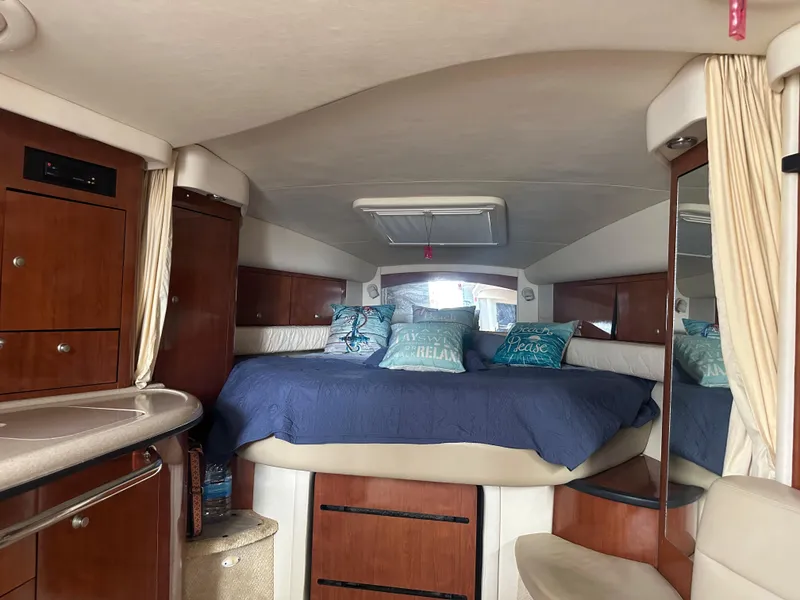 Slide: The Image of Interior cabin of a 2006 Sea Ray 340 Sundancer yacht with bed and storage. - 55