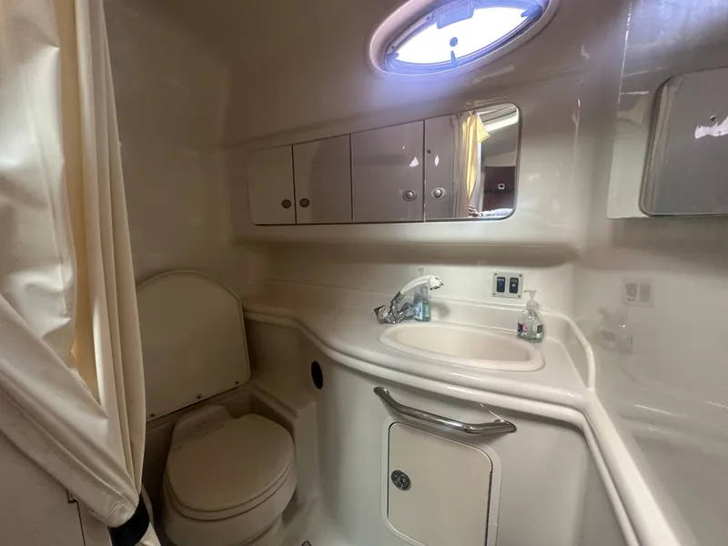 Slide: The Image of 2006 Sea Ray 340 Sundancer bathroom with sink, toilet, and storage cabinets. - 58