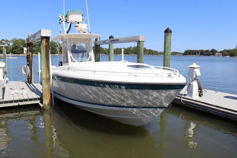 Slide: The Image of 1997 Intrepid 322 boat docked on a sunny day by the water. - 1