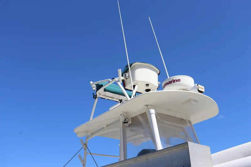 Slide: The Image of 1997 Intrepid 322 boat radar and antenna against clear blue sky. - 11