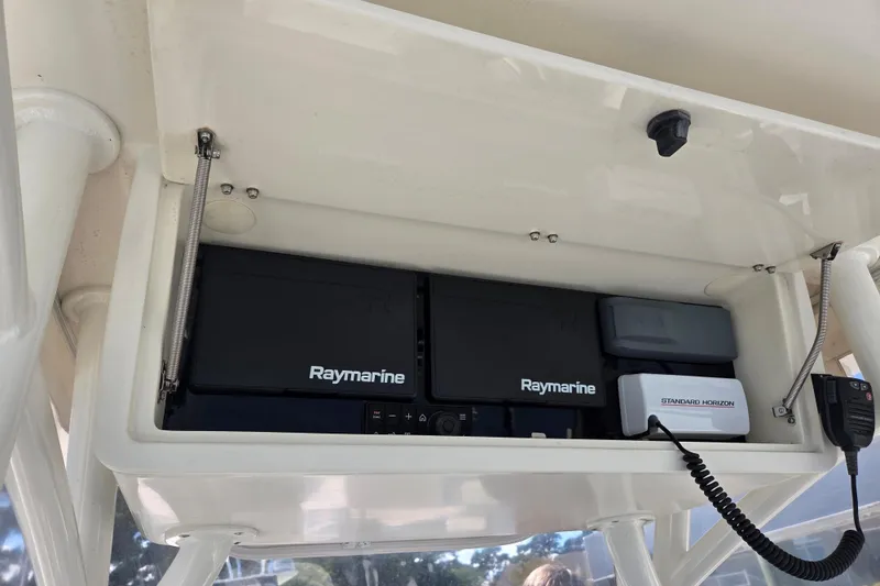 Slide: The Image of 1997 Intrepid 322 boat electronics, featuring Raymarine and Standard Horizon equipment. - 14