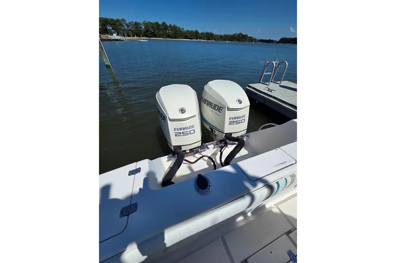 Slide: The Image of 1997 Intrepid 322 boat with dual Evinrude 250 outboard motors docked by the water. - 15