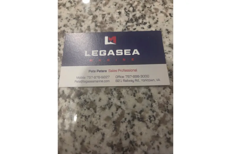 Slide: The Image of Business card for Legasea Marine on a granite surface. - 16