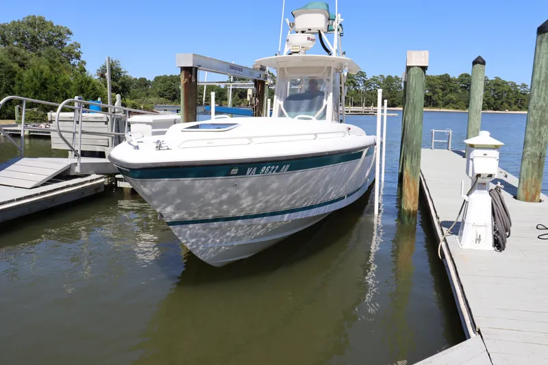 Slide: The Image of 1997 Intrepid 322 boat docked at a marina on a sunny day. - 2