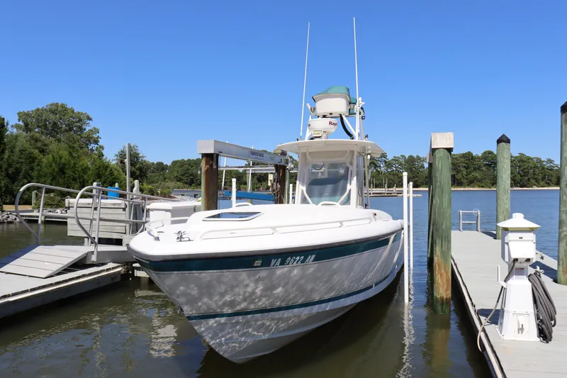 Slide: The Image of 1997 Intrepid 322 boat docked at marina under clear blue sky. - 3