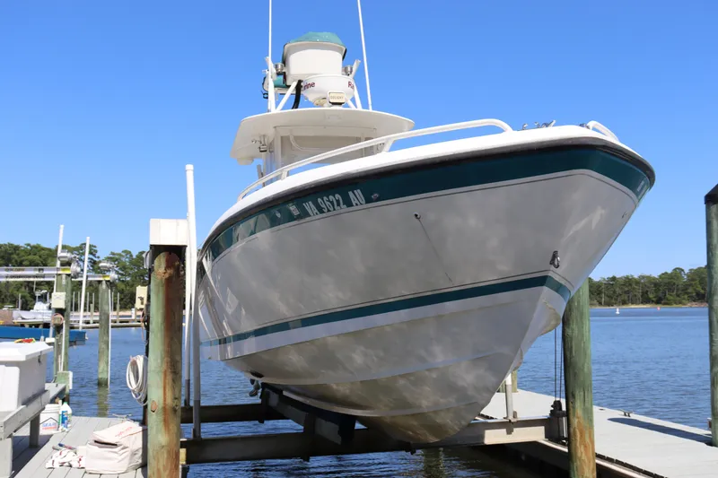 Slide: The Image of 1997 Intrepid 322 boat docked on a sunny day, showcasing its sleek design. - 9