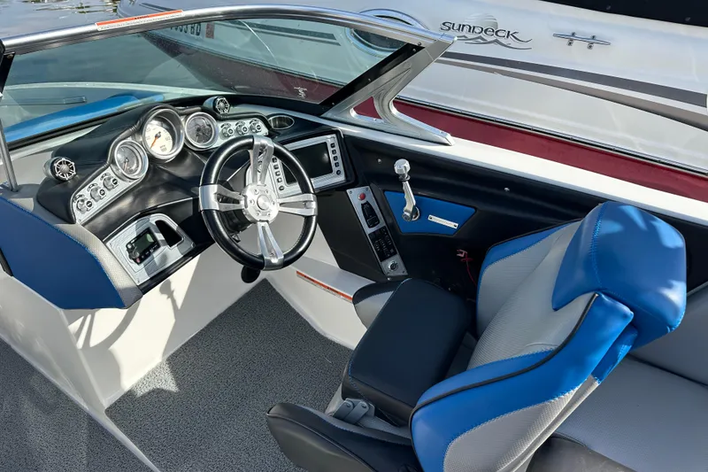Slide: The Image of 2016 MasterCraft X23 boat interior with modern dashboard and blue seating. - 13