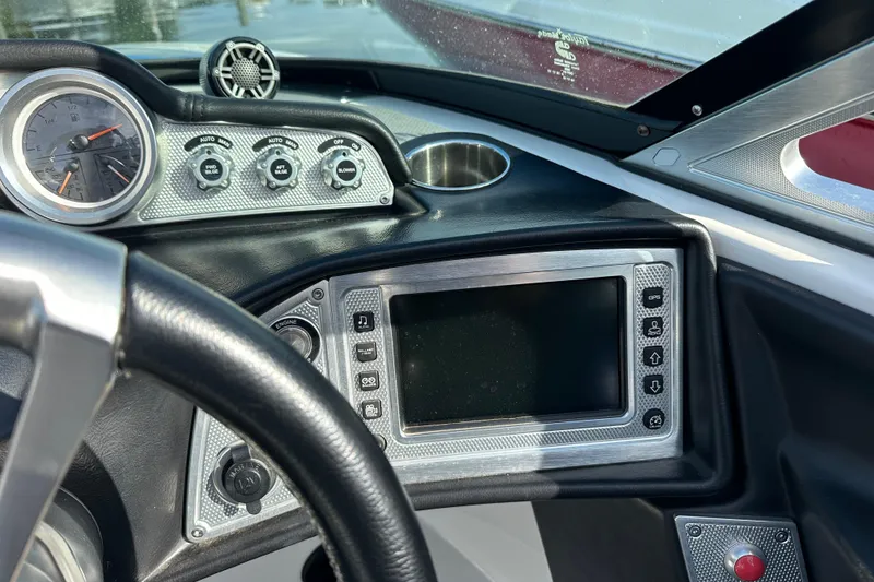 Slide: The Image of Dashboard of a 2016 MasterCraft X23 boat with gauges and controls. - 16