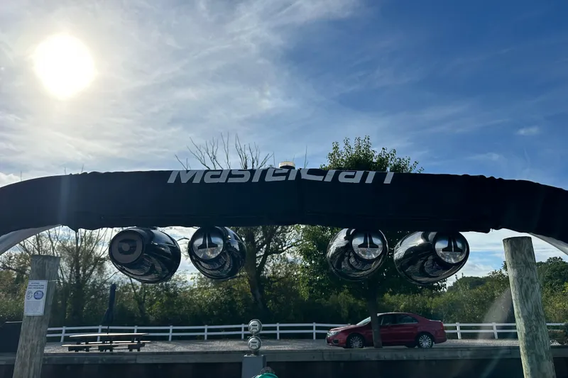Slide: The Image of 2016 MasterCraft X23 boat speakers under sunny sky at dock. - 30