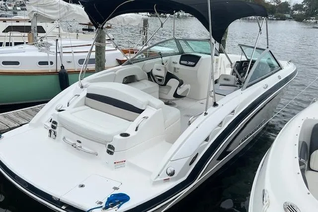 The Image of 2011 Chaparral 224 Sunesta boat docked, featuring spacious seating and sleek design. - 0