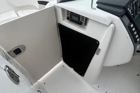 Slide: The Image of 2011 Chaparral 224 Sunesta boat interior with control panel and storage compartment. - 12