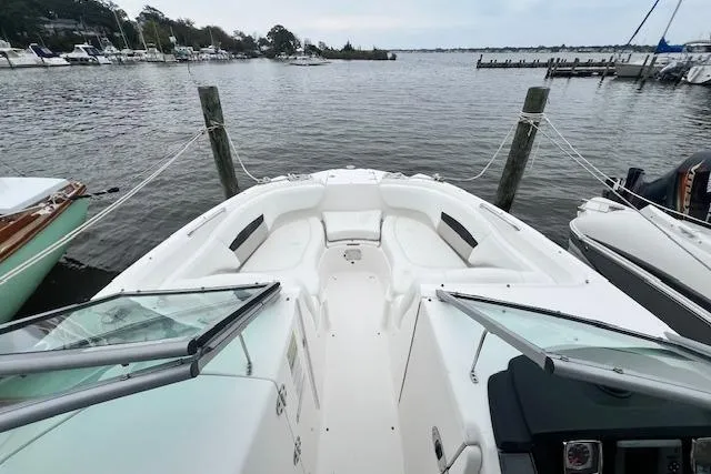 Slide: The Image of 2011 Chaparral 224 Sunesta boat docked at a marina, featuring spacious seating. - 17