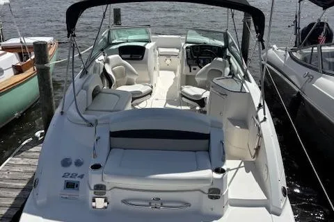 Slide: The Image of 2011 Chaparral 224 Sunesta boat docked, featuring spacious seating and sleek design. - 3