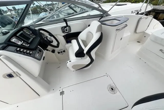 Slide: The Image of 2011 Chaparral 224 Sunesta boat interior with steering wheel and seating. - 8