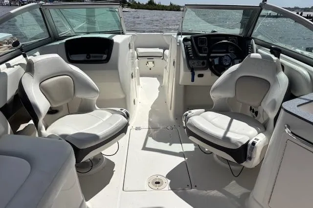 Slide: The Image of 2011 Chaparral 224 Sunesta boat interior with white seating and dashboard view. - 9
